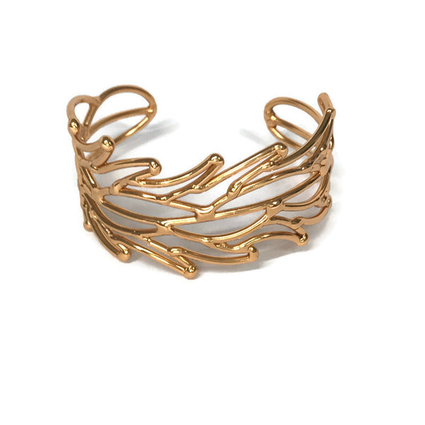bracelet en laiton doré, maillage en forme de petites flammes, sur environ 3 cm de large, vue de face