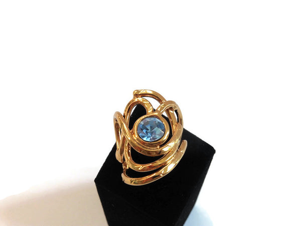bague en laiton doré et verni avec strass au centre ; toute en courbes légères, vue de face