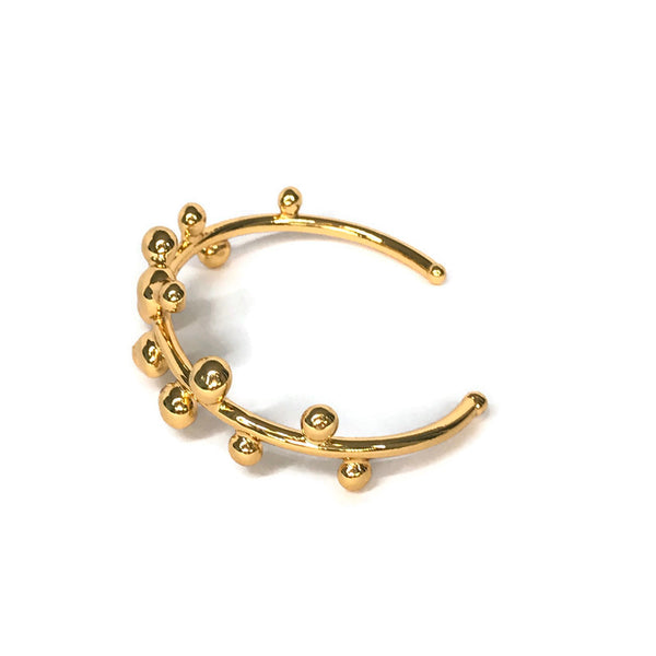 bracelet jonc orné de petites boules de métal fondu sur le pourtour, doré, vue de côté