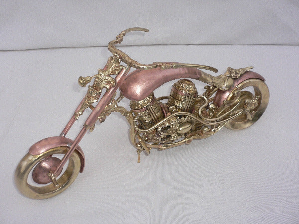 moto chopper constituée par assemblage de ferronneries anciennes, laiton, cuivre et bronze, façon steampunk, vue de biais